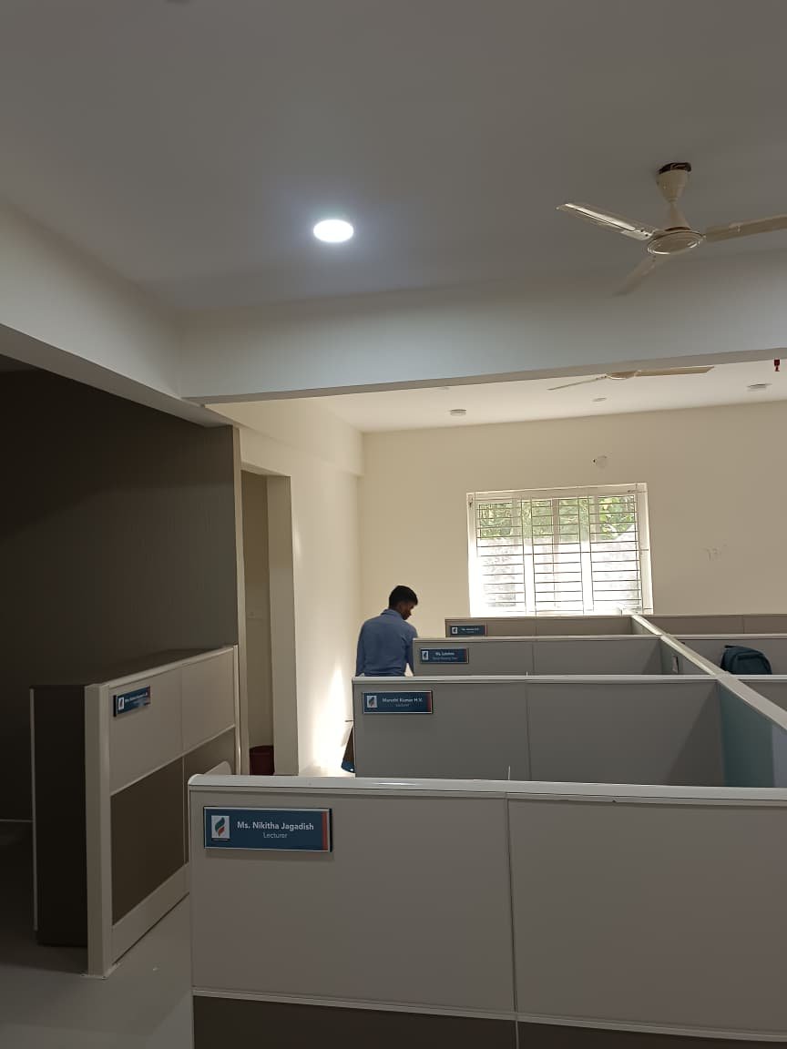 Technician treating an office workspace for pests